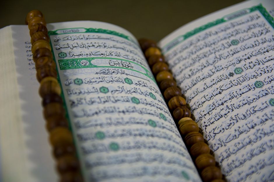 An open Quran on a wooden stand, symbolizing the guidance found in Tawakkul in Islam.