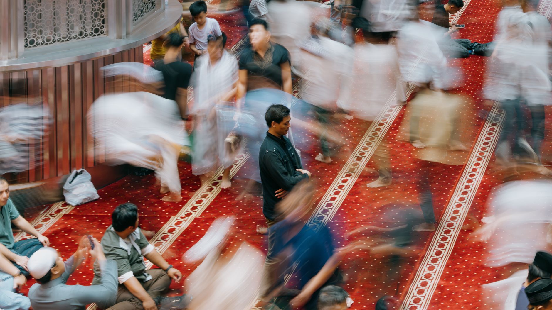 A person reading the Quran and reflecting on Salawat upon the Prophet Muhammad ﷺ in a quiet space.