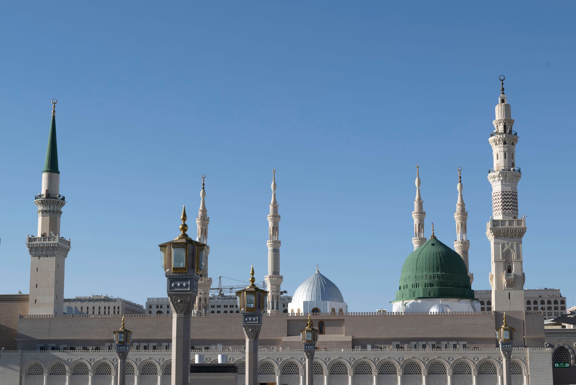 A person reading the Quran in a peaceful setting while focusing on Salawat upon the Prophet ﷺ.