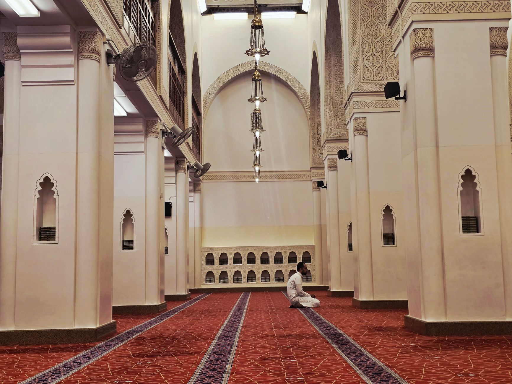 A person reading the Quran to gain knowledge before performing Istikhara prayer for guidance.
