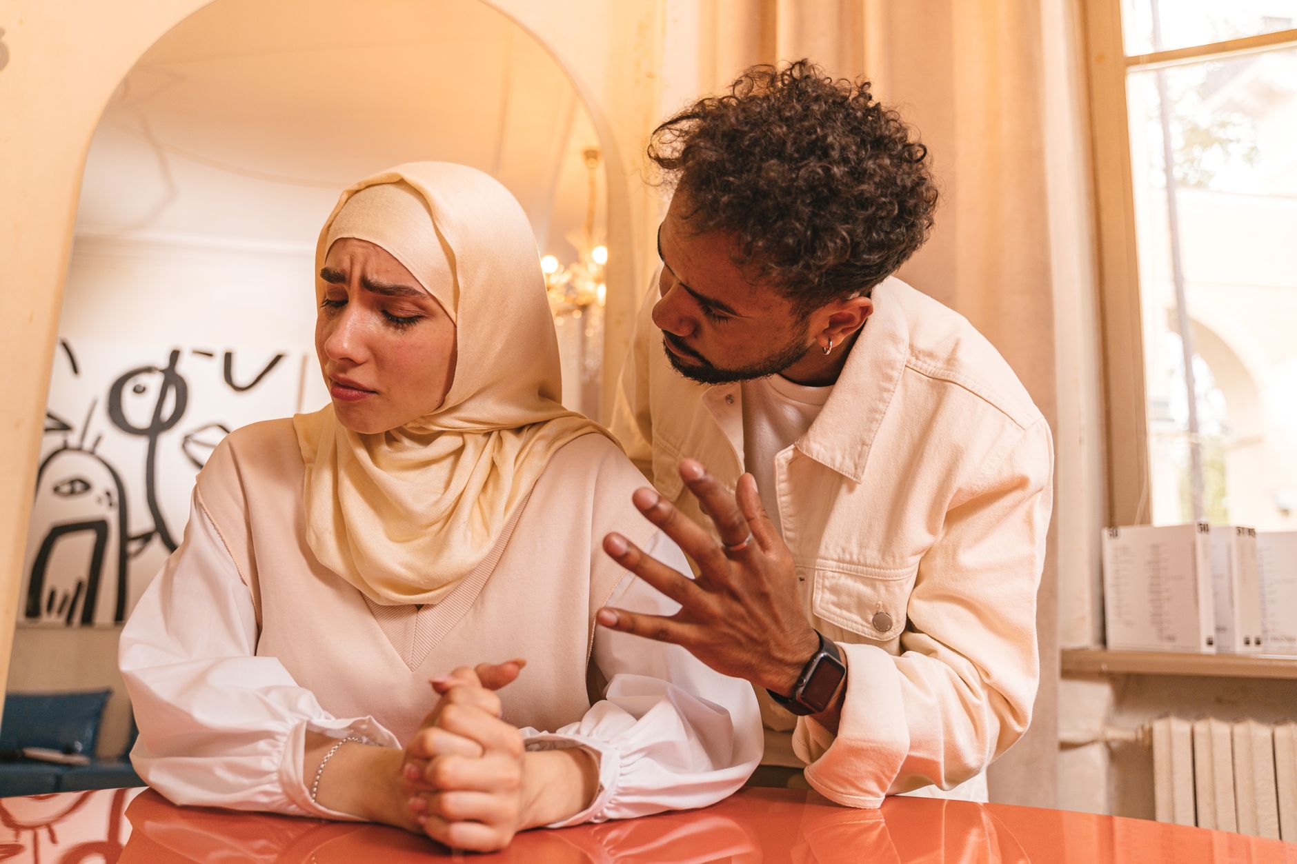 A husband and wife sharing tea, focusing on love and mercy to avoid marital conflict in Islam.