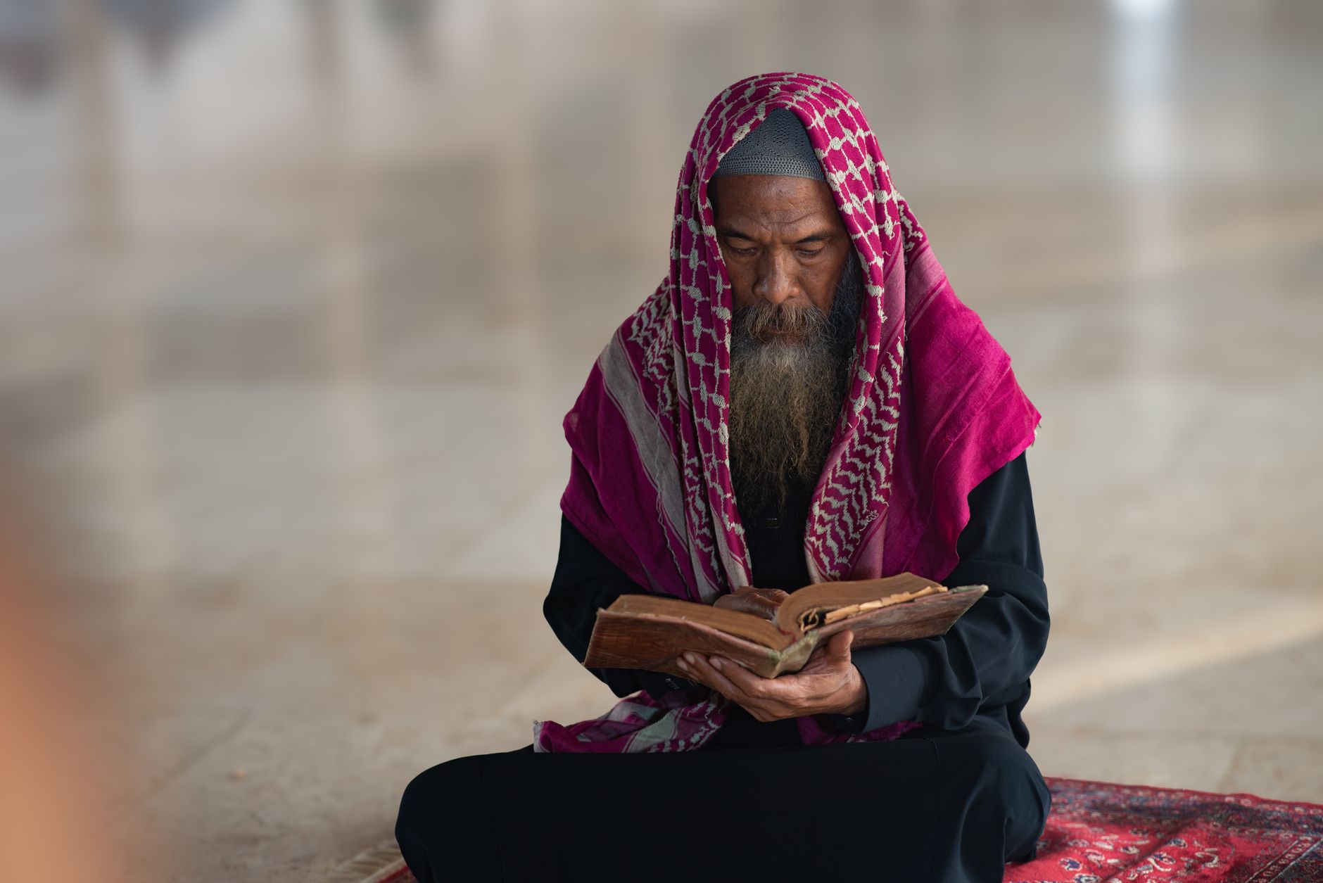 A person reading the Quran, reflecting on the teachings of Prophet Ishaq to guide modern life.