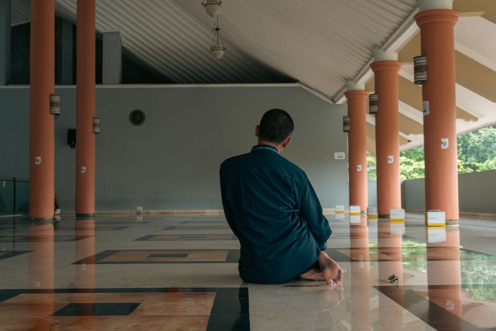 A person reading the Quran as part of using social media in Islam responsibly.