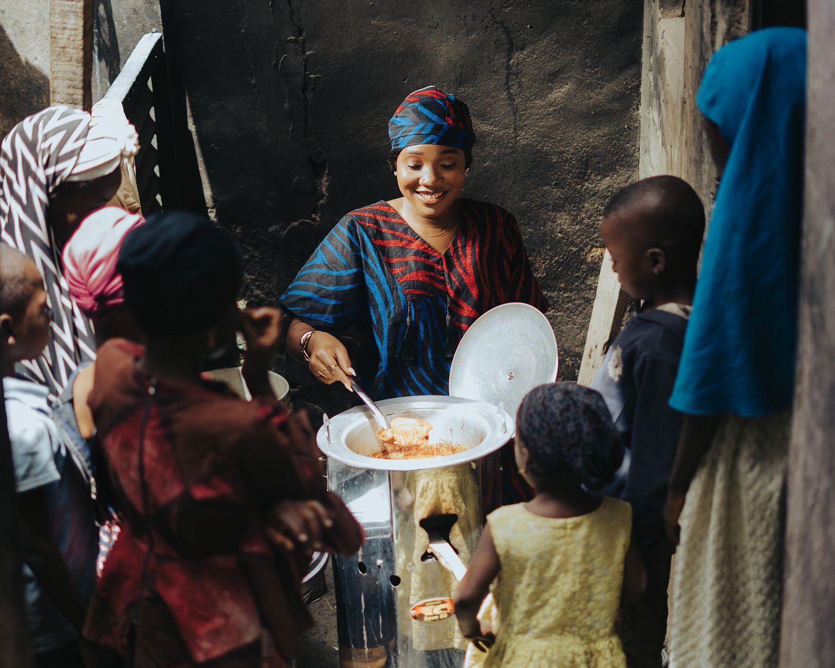 A person helping others to learn who can receive Zakat in a community setting.