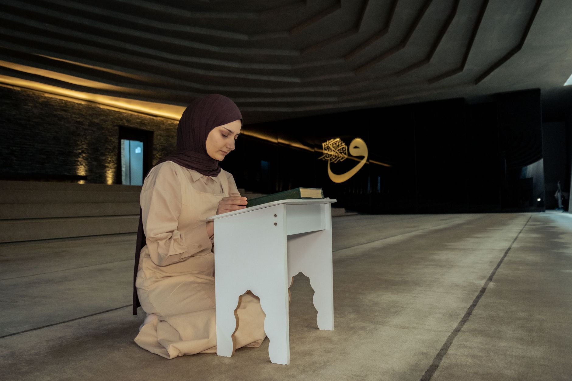 A person focusing on avoiding mistakes during Salah while reading the Quran with respect.