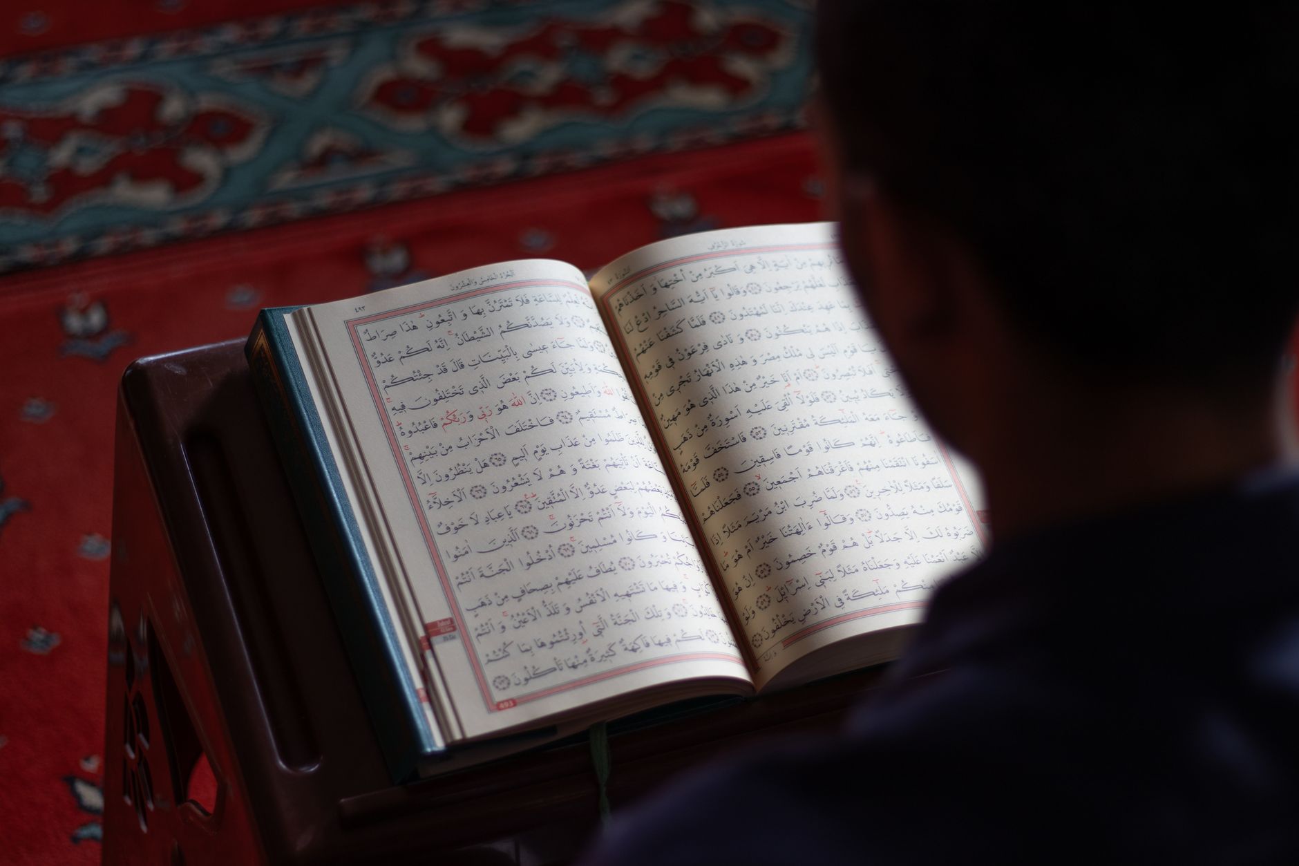 A quiet corner for daily Quran reading with a prayer rug and a Quran.