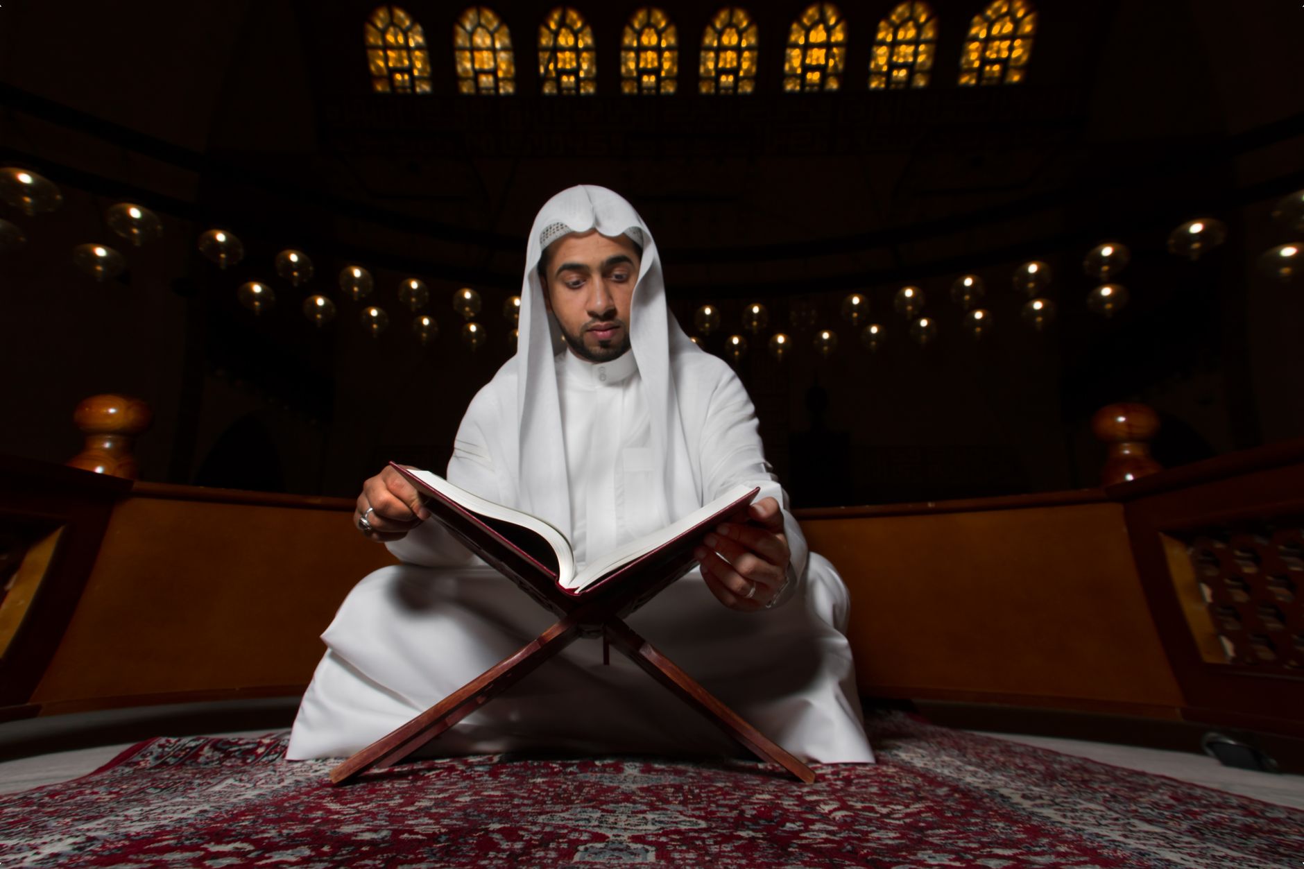 An open Quran on a table, representing the act of reflecting on the Quran.