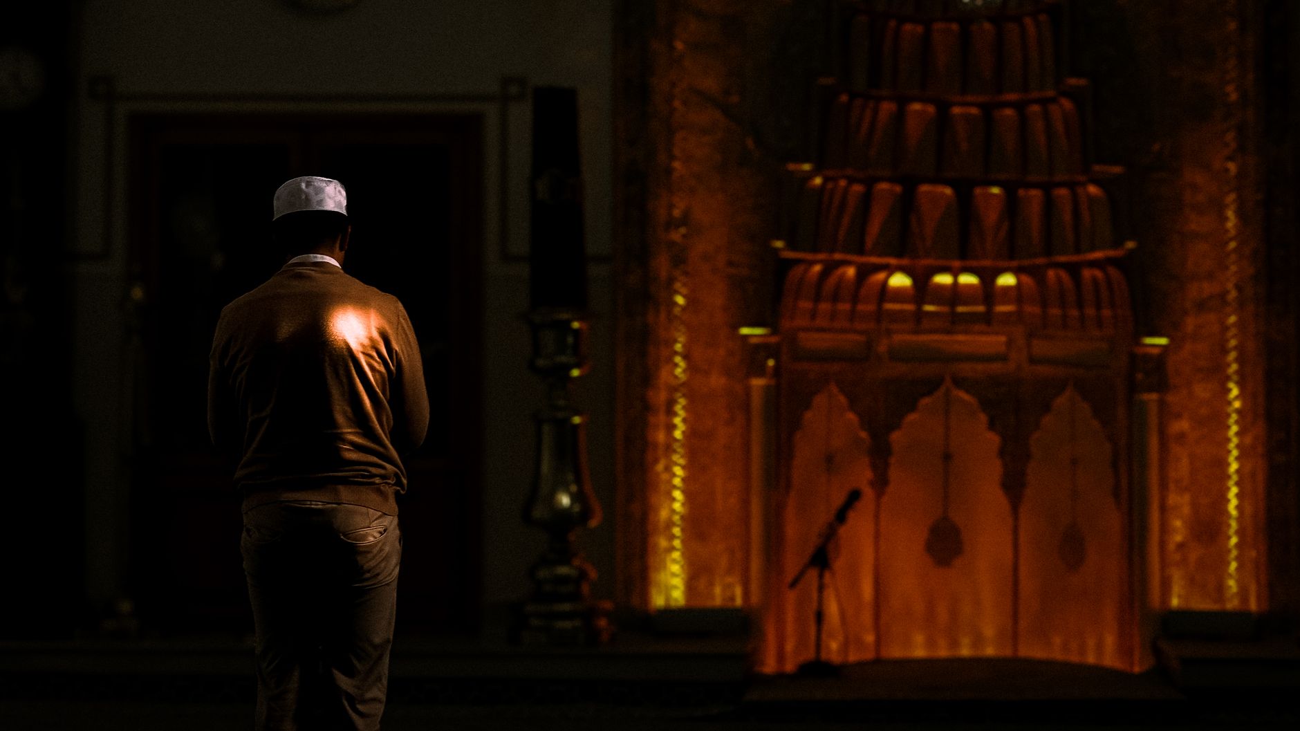 A person reading the Quran to improve concentration in Salah by understanding the words.