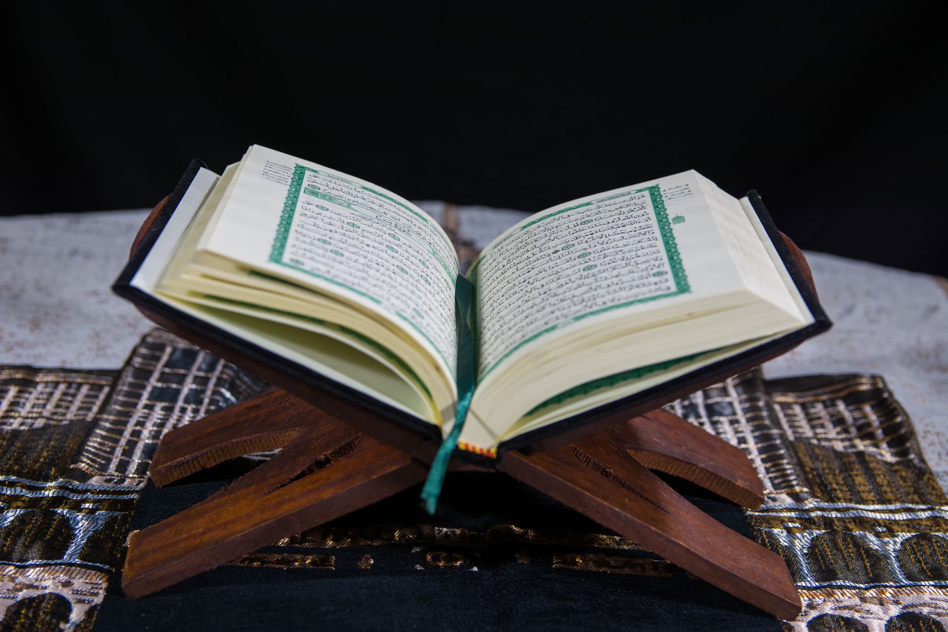 An open Quran book symbolizing the divine guidance revealed alongside the Prophet Musa staff.